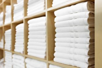 white towels stacked in cupboard